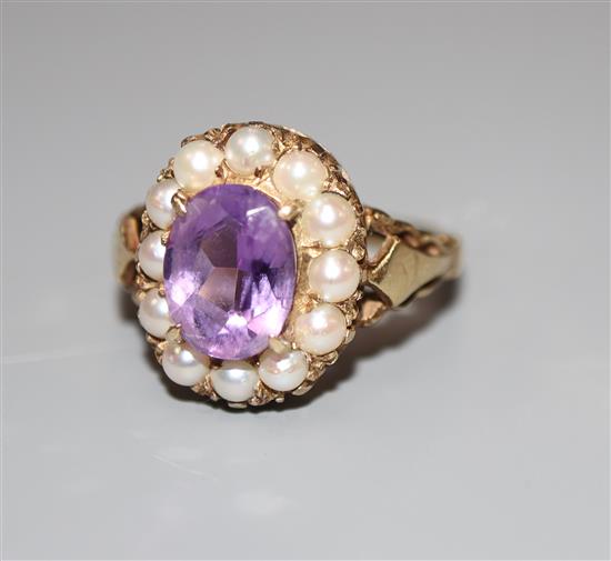 A 9ct, amethyst and split pearl set oval dress ring, size L, gross 3.6 grams.